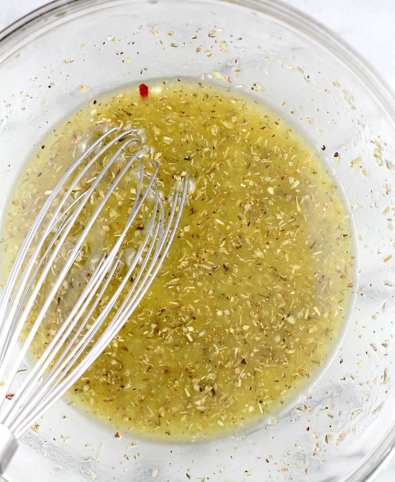 top down view of the marinade in a glass bowl with a whisk