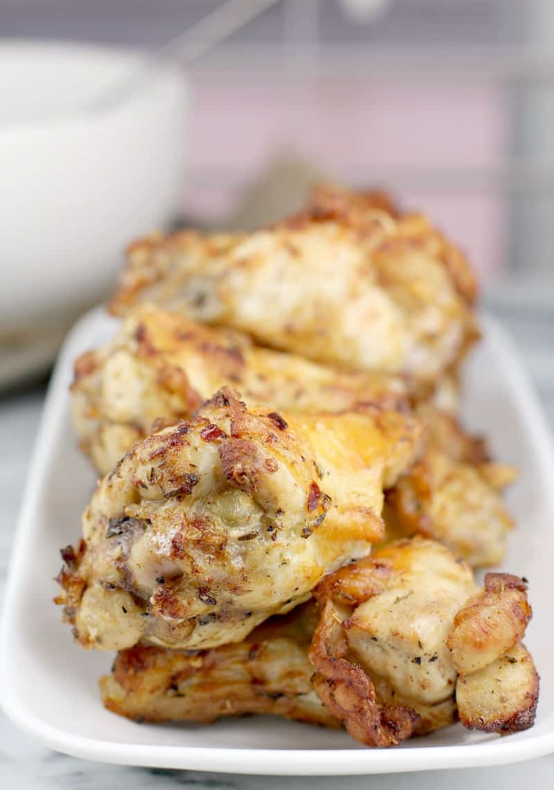 close-up of cooked air fryer chicken wings on a white dish