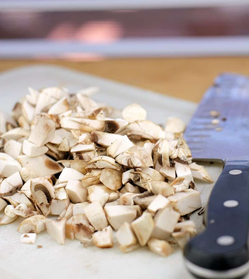 chopped mushrooms on a white board