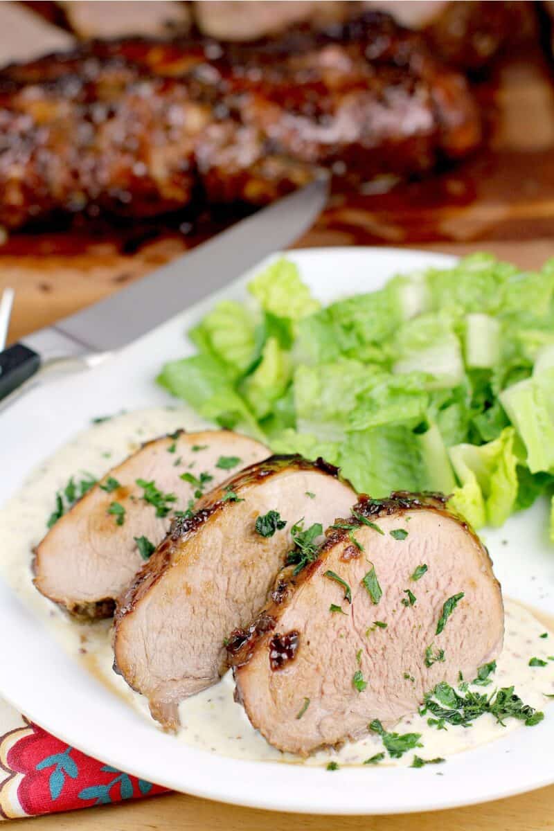 plated recipe, knife and pork roast in the background