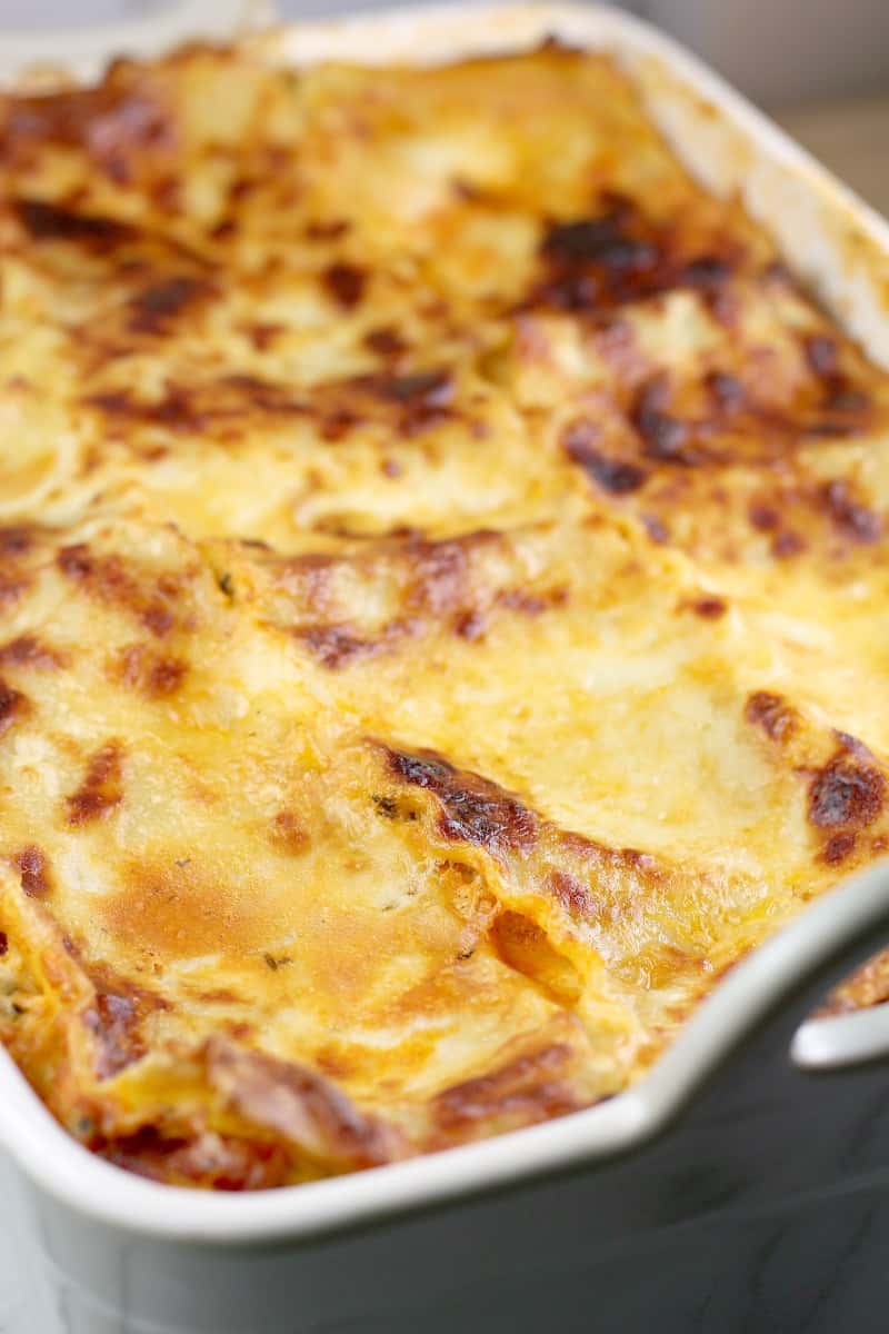 angled view of the classic lasagna, fully cooked in a ceramic lasagna dish