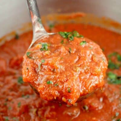 zoomed view to show the finished marinara sauce recipe in the pot with a silver ladle