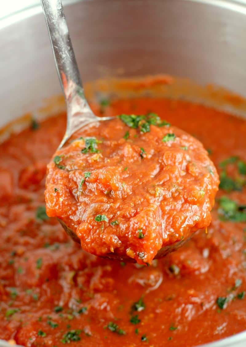 zoomed view to show the finished marinara sauce recipe in the pot with a silver ladle