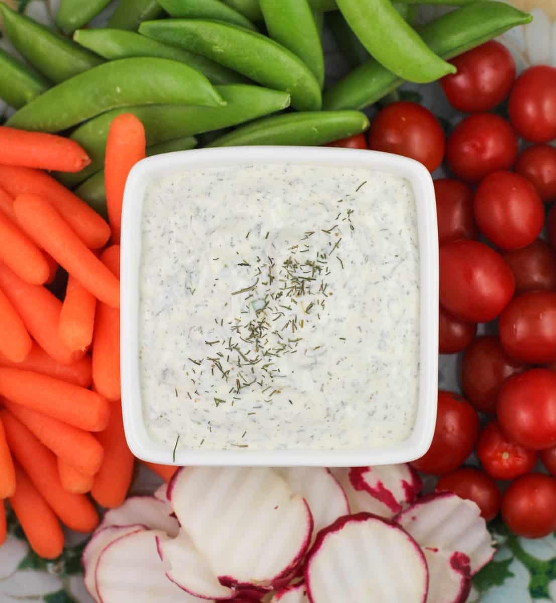 prepared veggie dip in small white dish in the center of vegetable platter