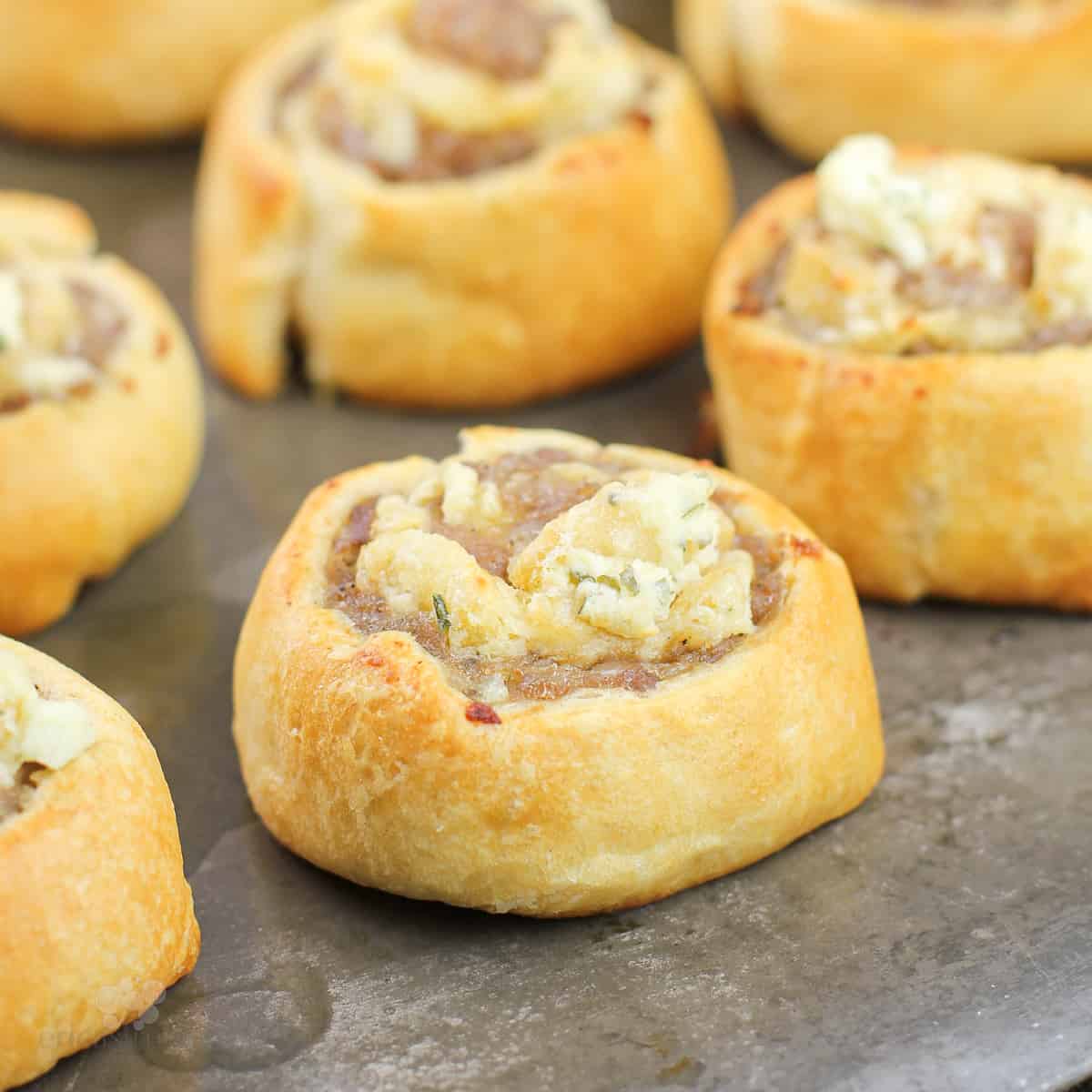 prepared crescent roll sausage pinwheels with Boursin on bake sheet