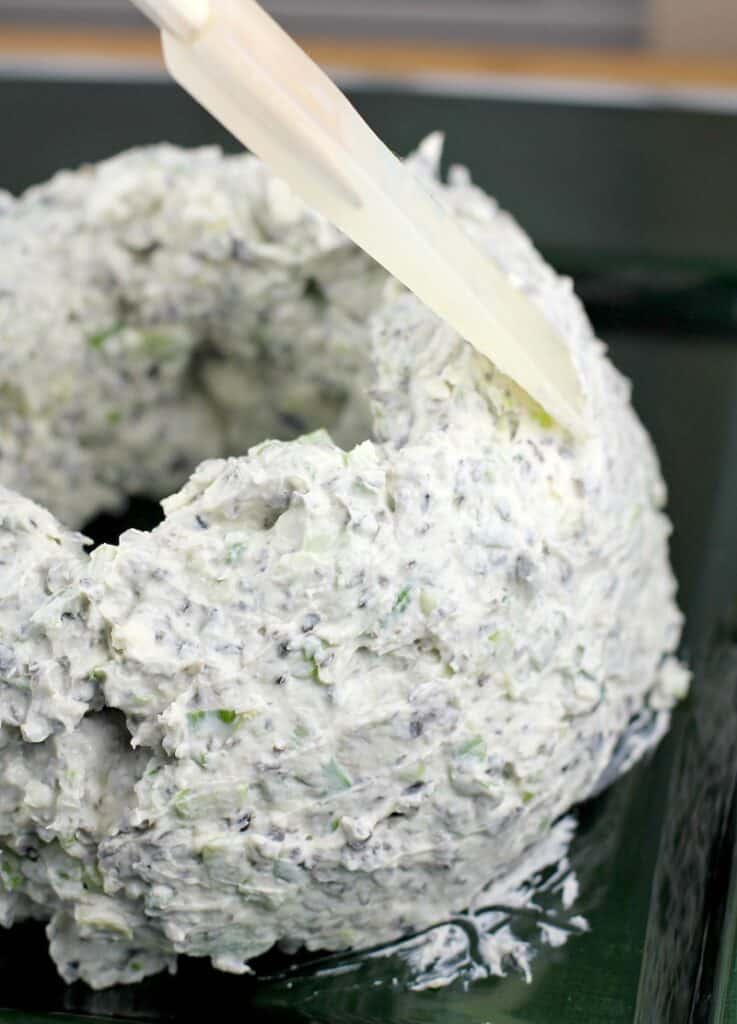 view of a rubber spatula smoothing out the wreath