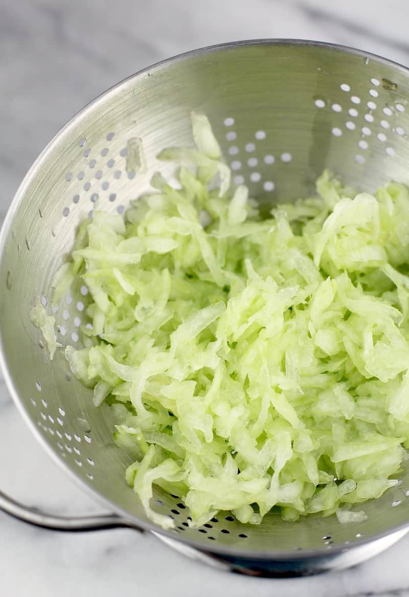shredded cucumber for this healthy veggie dip in a strainer