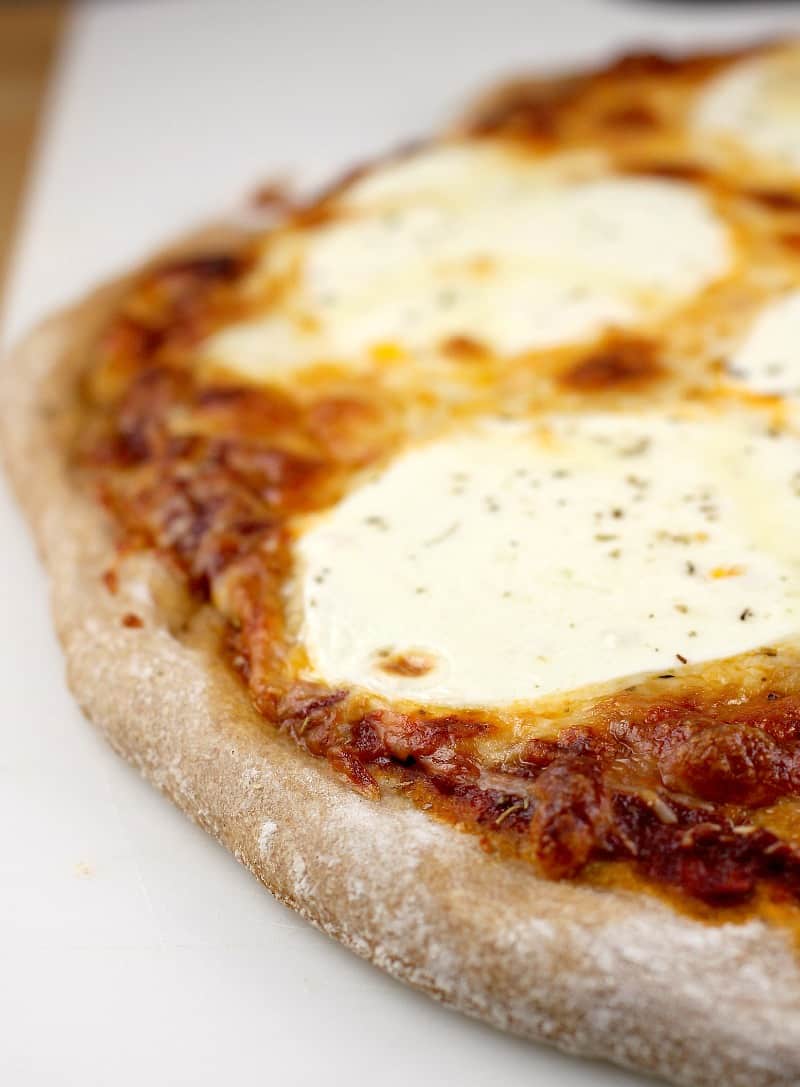 a cooked cheese pizza showing cooked crust