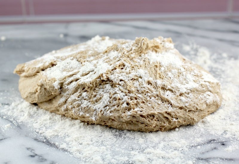 view of the dough on a white marble surface after the first rise