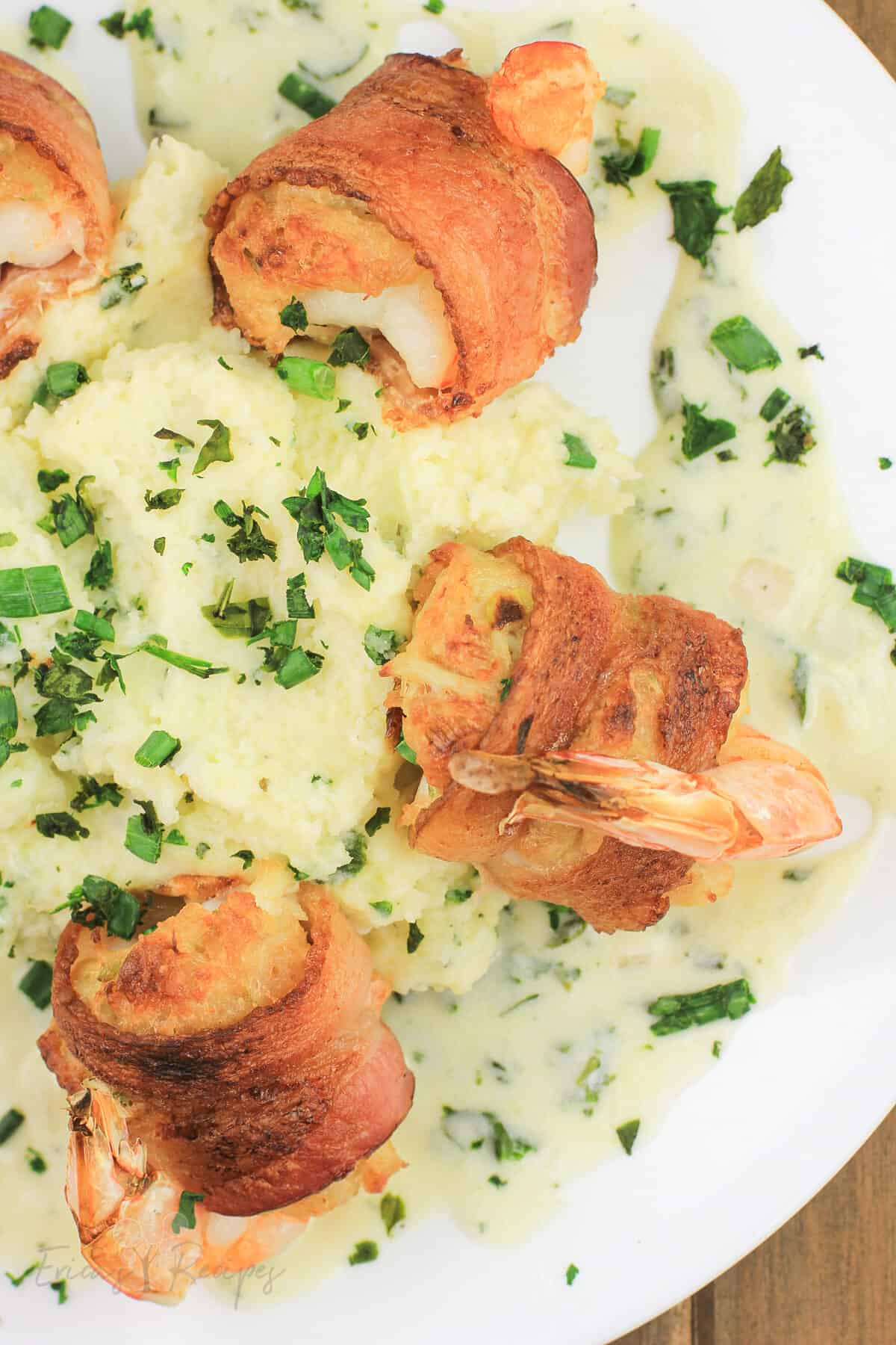 crab stuffed shrimp arranged around mashed potatoes on white plate