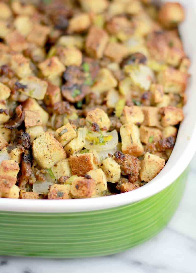 Angle down view of the finished stuffing in a green bake dish