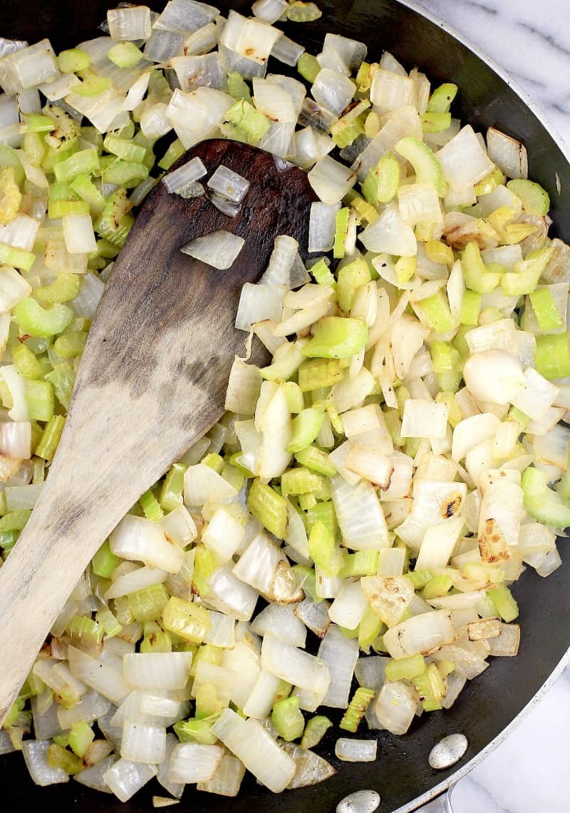 onion and celery cooked in a skillet.