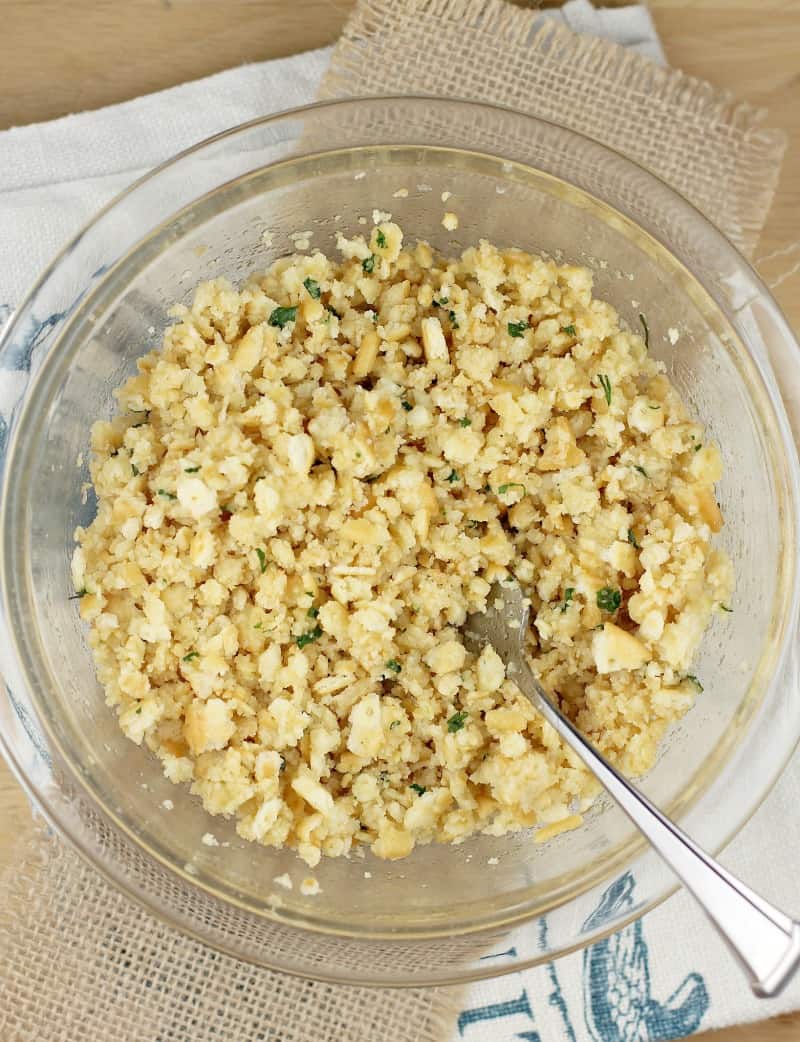 clear glass bowl with a spoon and the assembled topping mixture