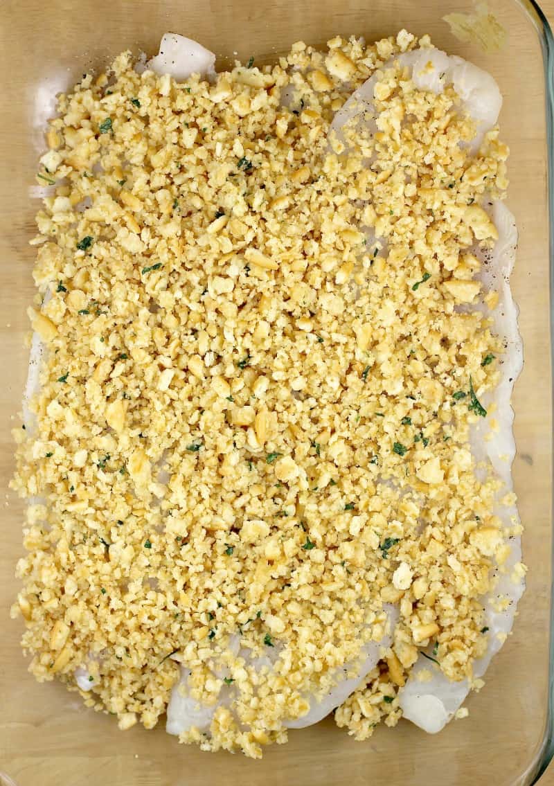 topping on fish assembled in bake dish