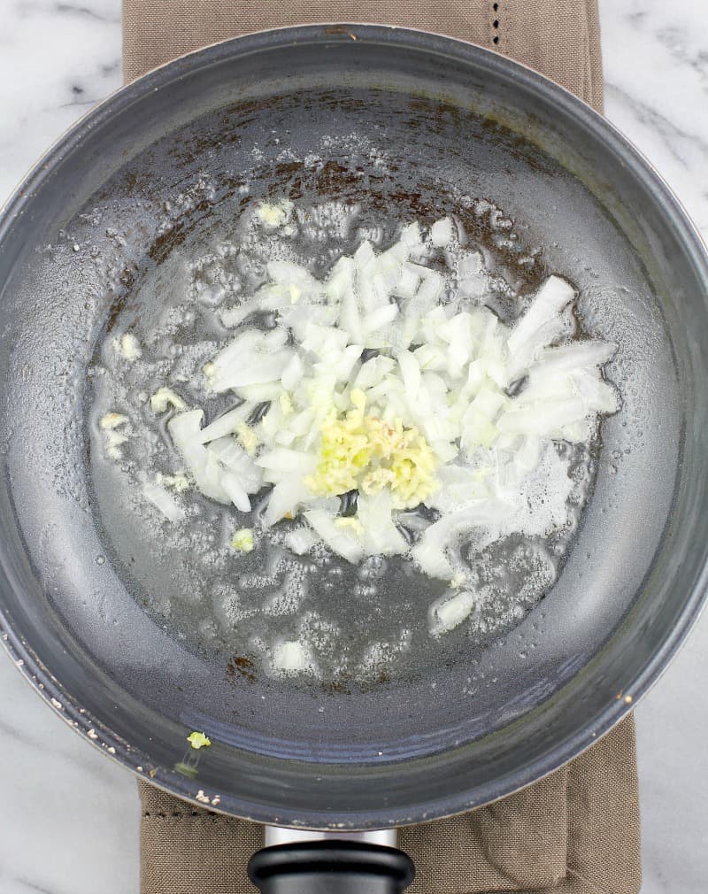 onion and garlic cooking in a saucepan