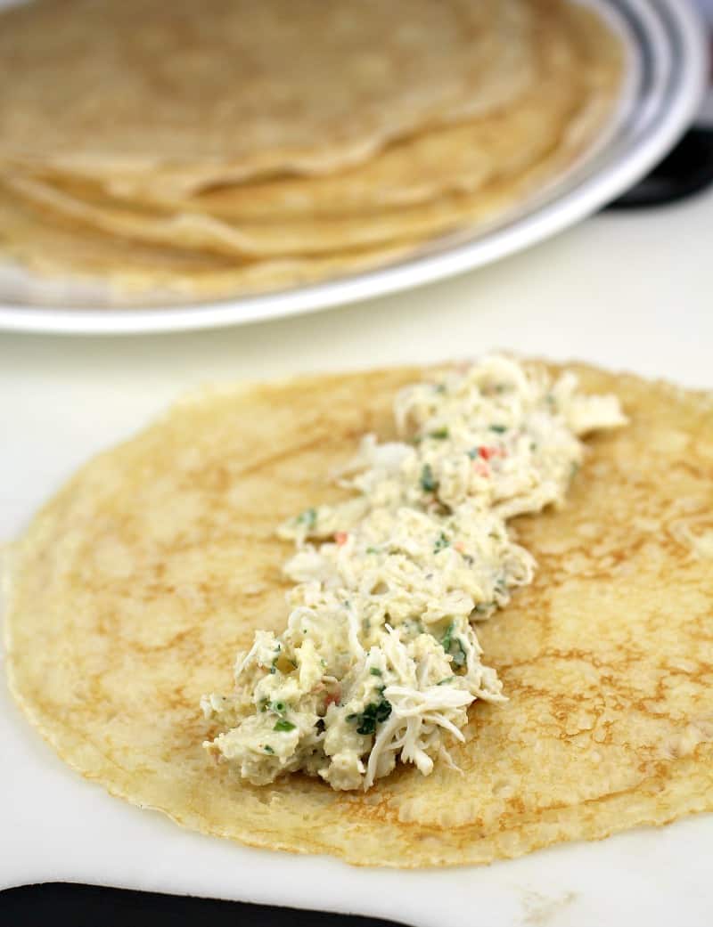 crepe on a white board with crab filling down the center