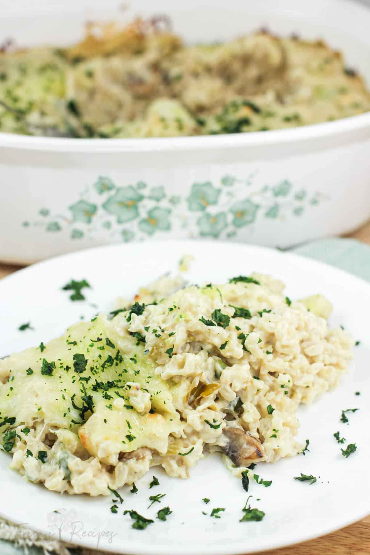 plated green chile rice on white dish in front of casserole dish