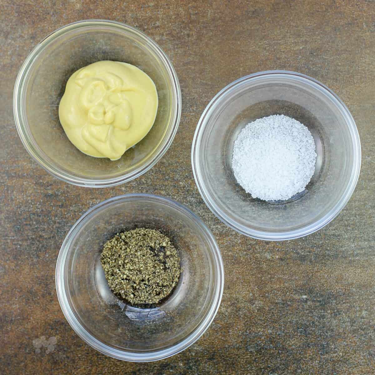 3 glass bowls to show ingredients Dijon mustard, salt, and pepper