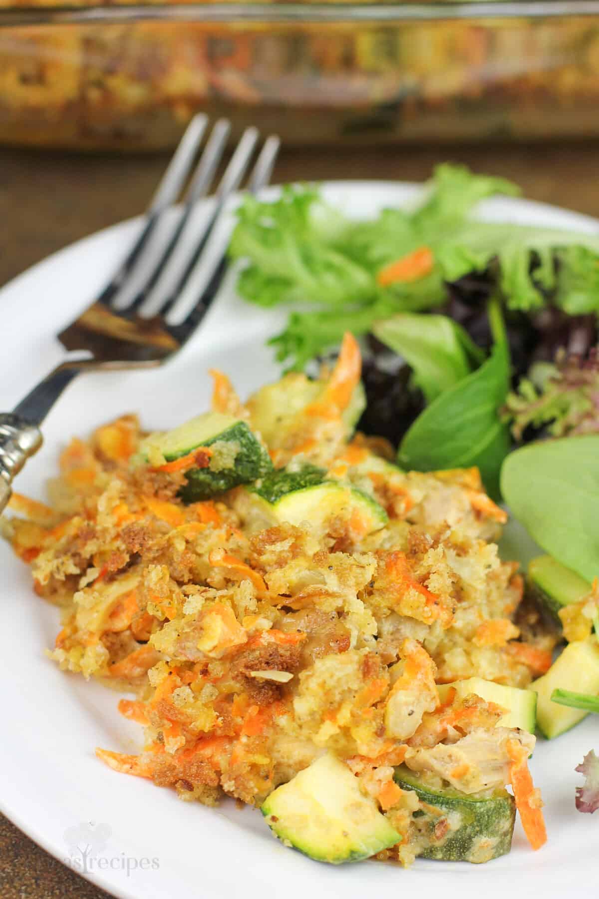 plated portion of recipe on white plate with fork and salad