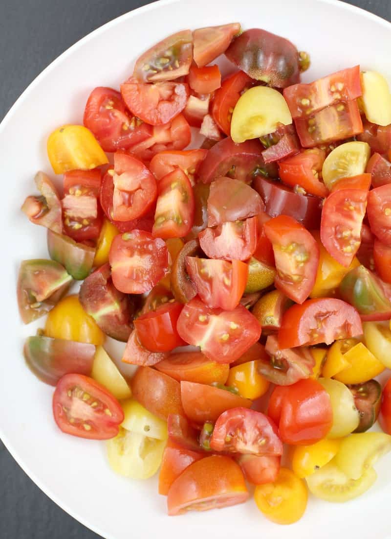 medley of chopped heirloom tomatoes on a white plate