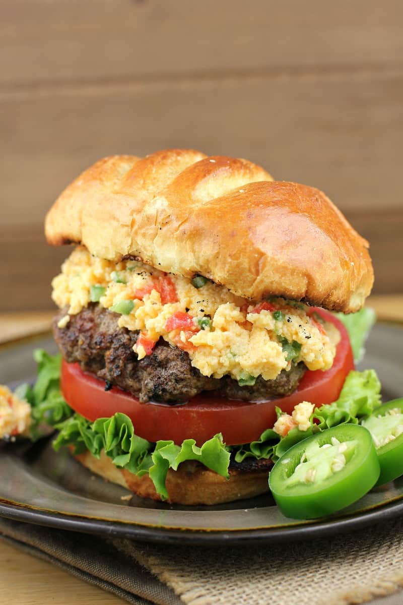 burger on a plate topped with pimento cheese