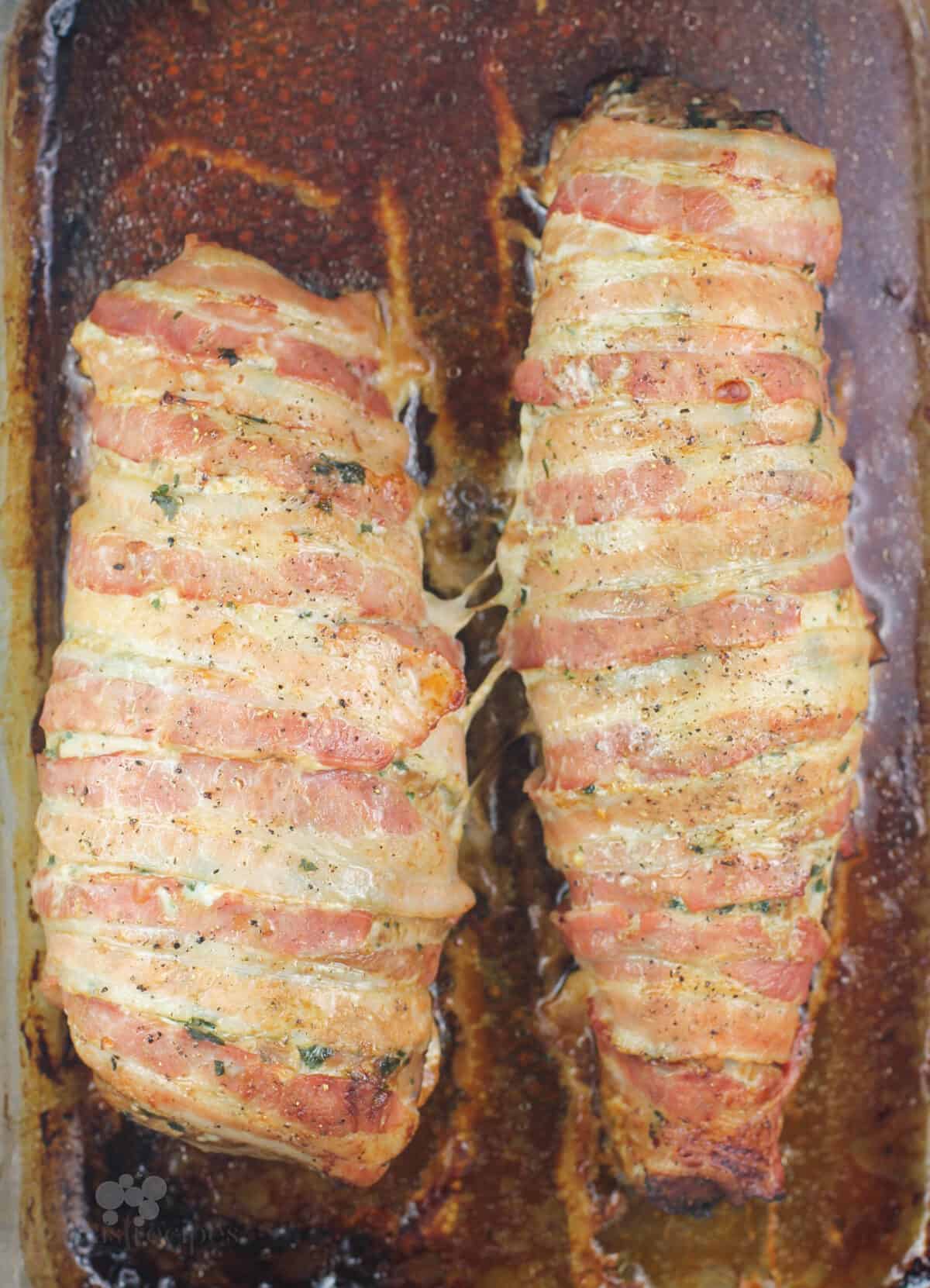 two bacon-wrapped pork roasts in bake dish