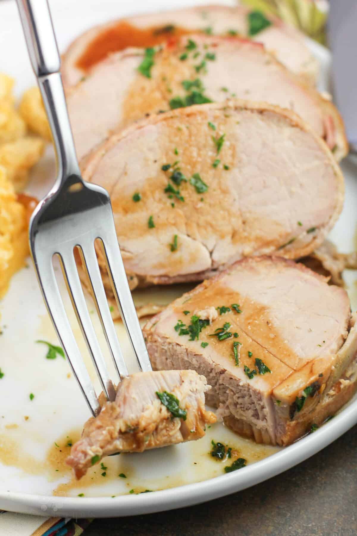 fork holding bite of pork