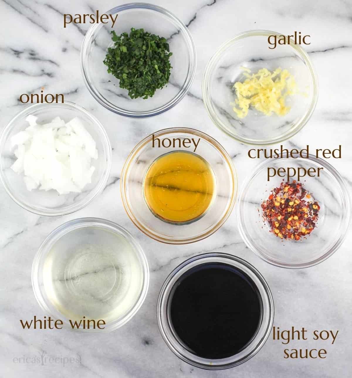 small glass bowls with marinade ingredients on marble surface