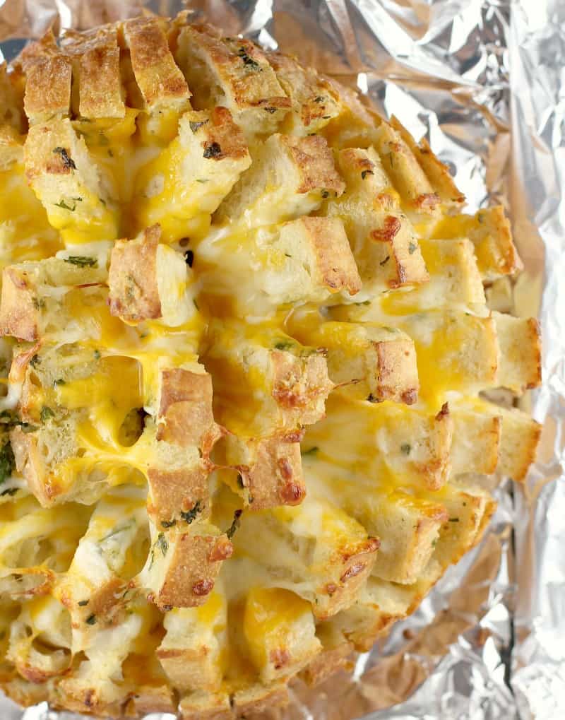 top down view of the finished stuffed cheesy bread on foil