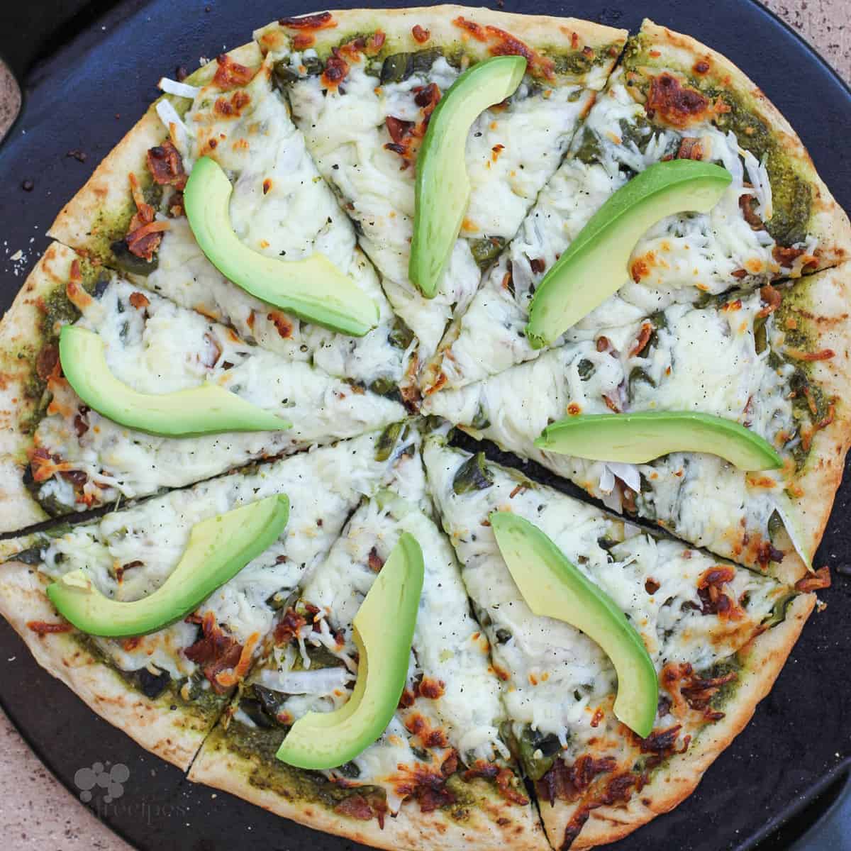 cooked pizza on black pizza stone