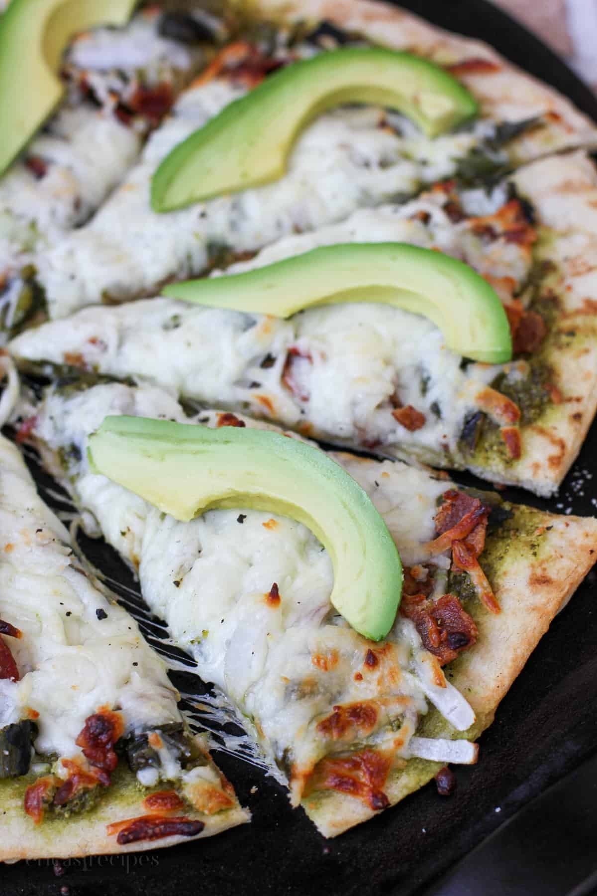 sliced pizza on black surface