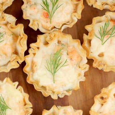 top down view of a mini smoked salmon tart with dill garnish