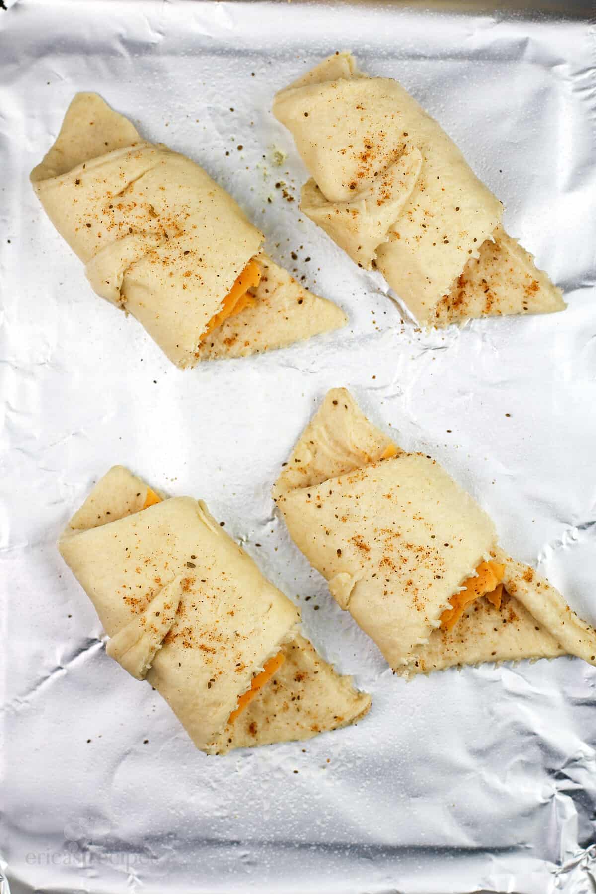 rolls up crescent dough before baking on bake sheet