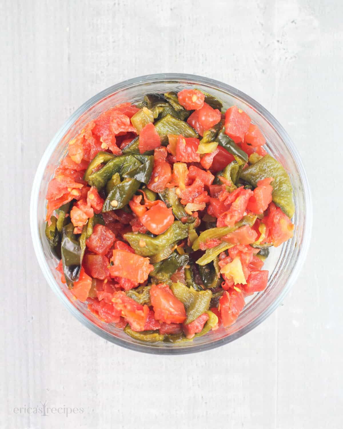 chopped tomatoes, green chiles, and poblano pepper in glass dish