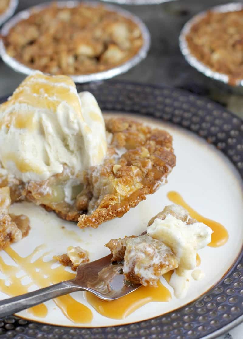 fork on a plate with apple crisp and ice cream