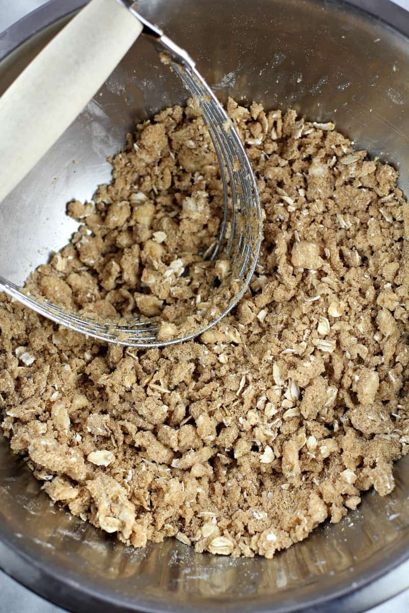 bowl with streusel mix and a pastry cutter