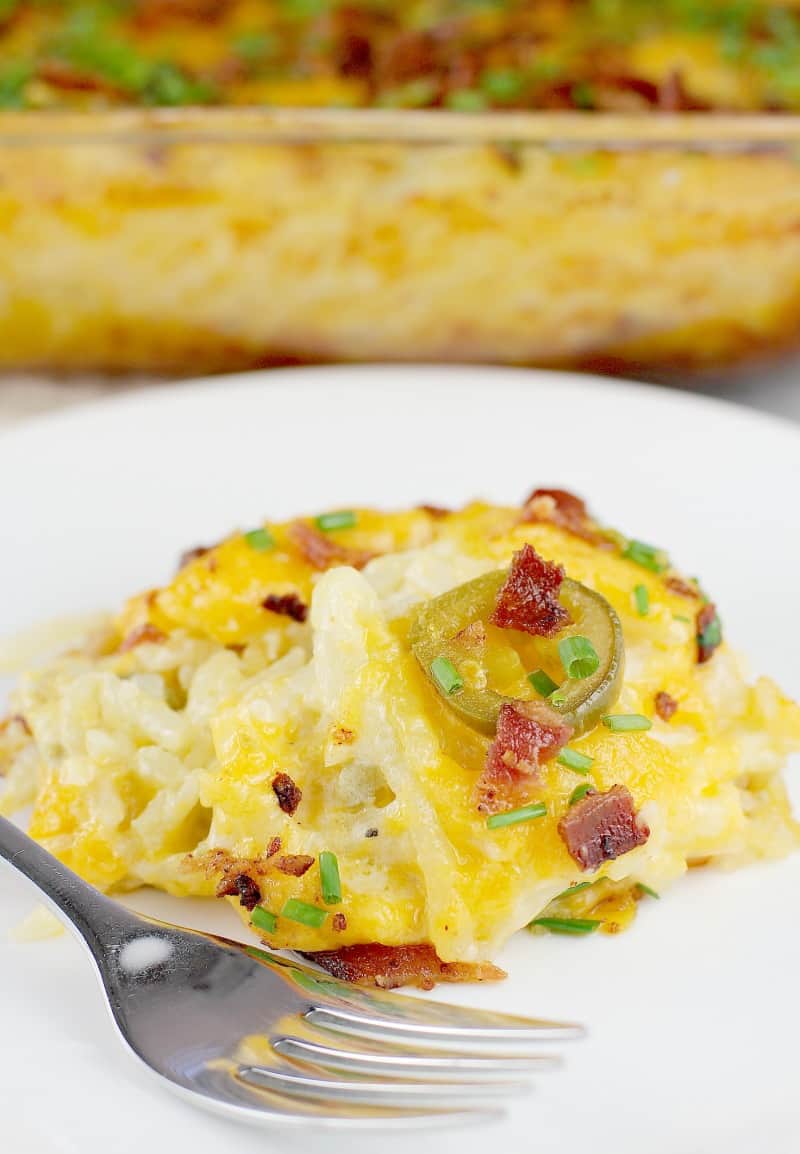 plated serving of hash brown casserole on a white plate with a fork