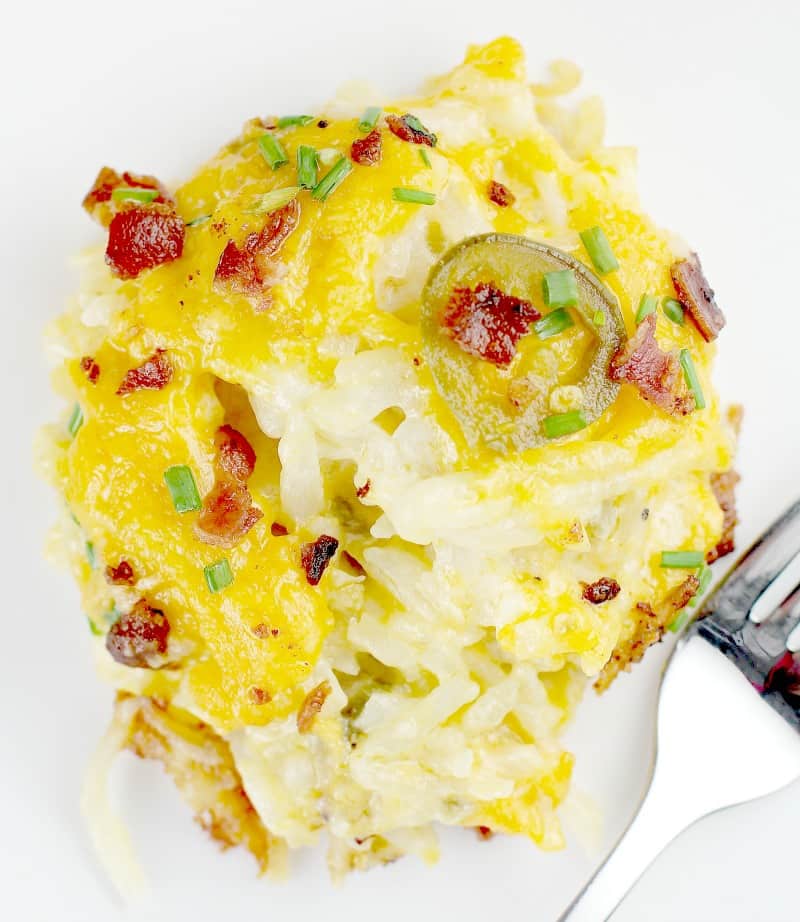 close shot of a spoonful of potato casserole on a white plate