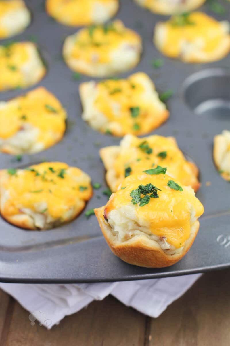 potato cup sitting on the rim of muffin pan