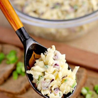 Russian garlic cheese in a rustic Russian spoon. The rest of this easy recipe for a party is in the background