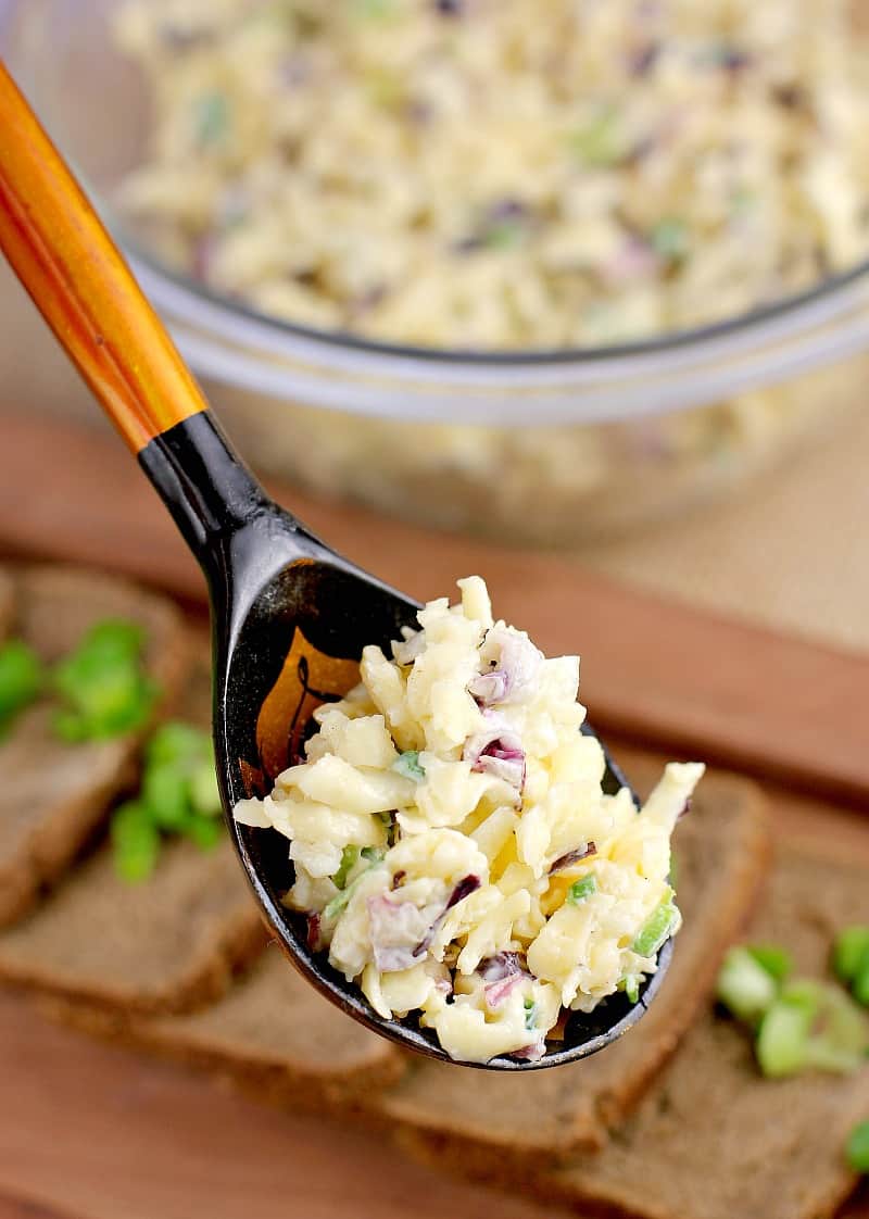 Russian garlic cheese in a rustic Russian spoon. The rest of this easy recipe for a party is in the background