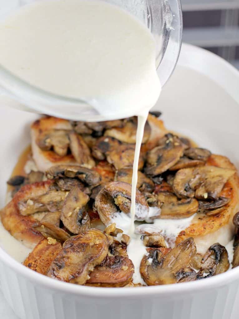 because this is a recipe for easy meal prep, this photo shows the quick sour cream sauce being poured over the mushrooms and seared chops