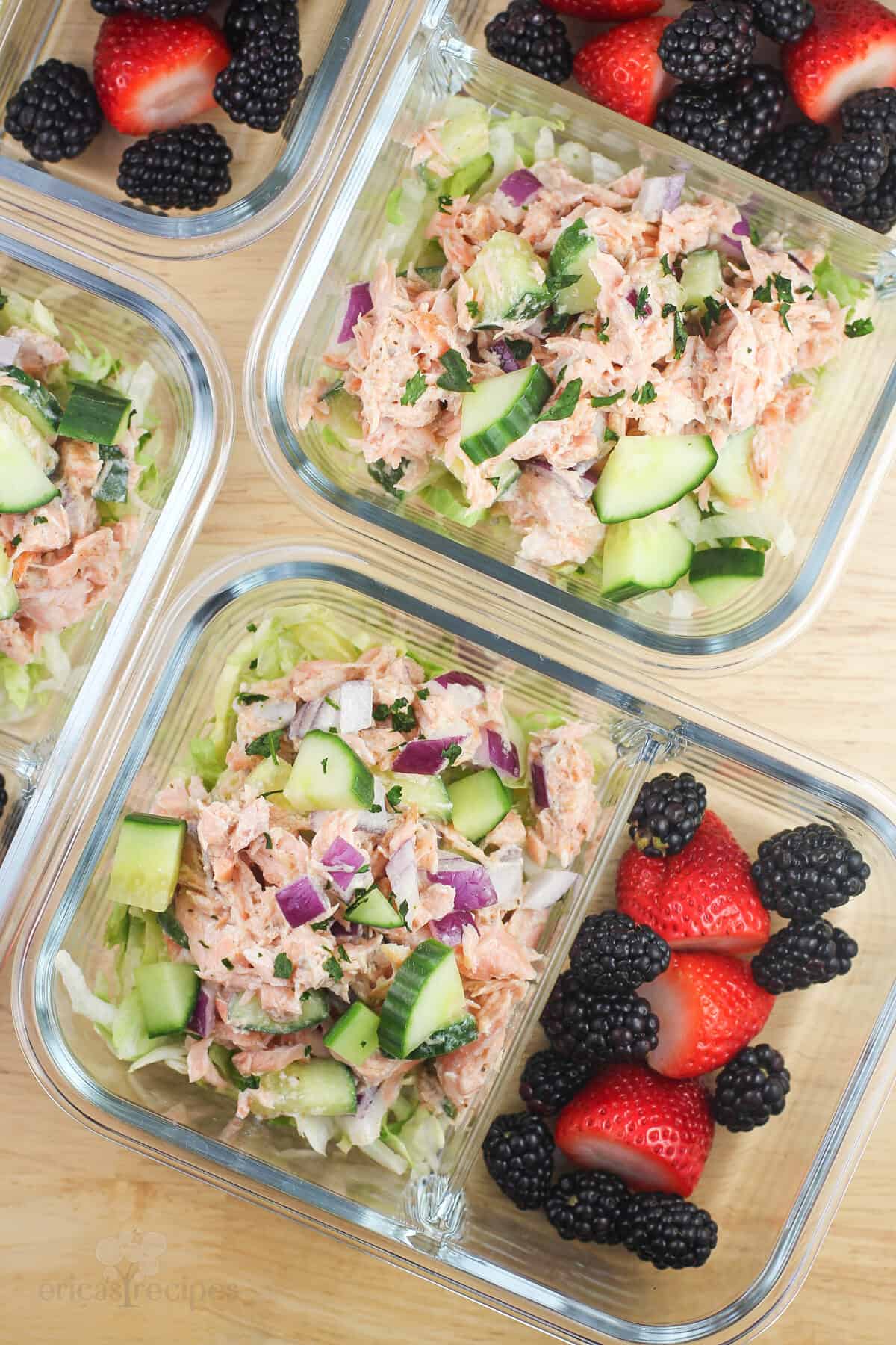 glass meal prep containers with salmon salad and berries