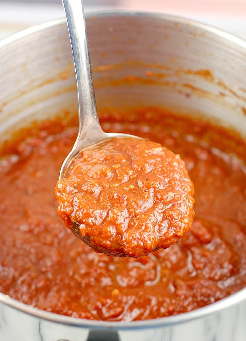 ladle scooping up cooked sauce