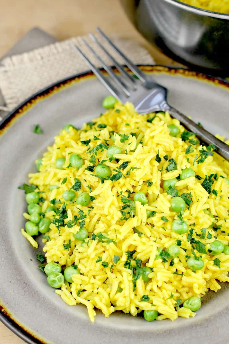 yellow rice and peas on a grey plate