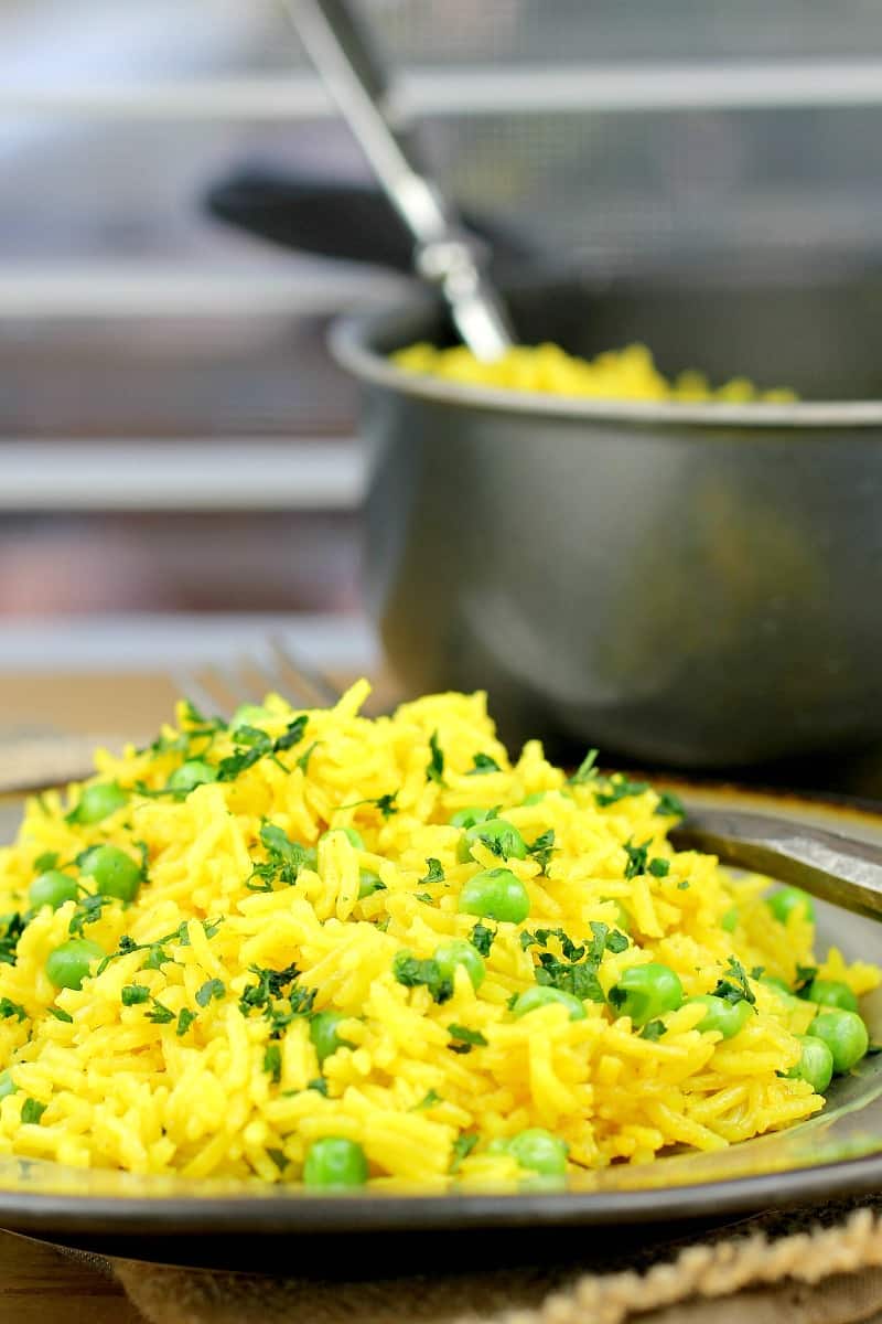 rice on a plate with a pot in the background