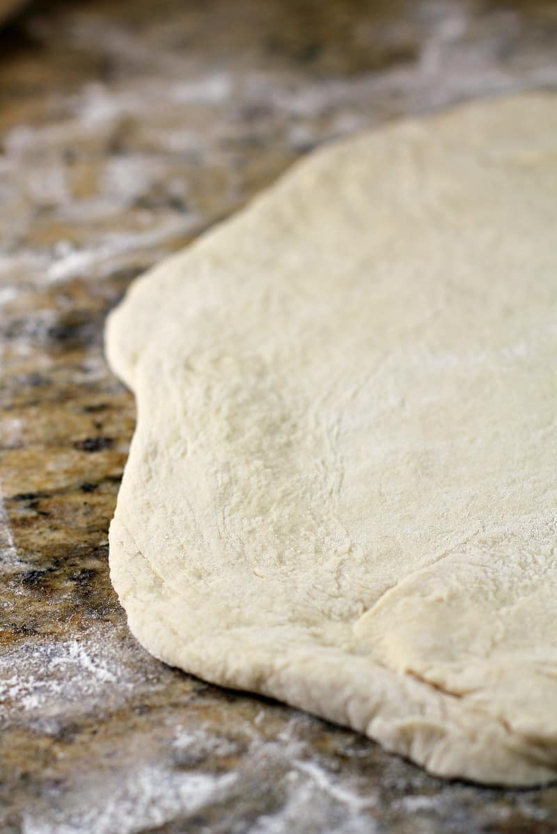 rolled out dough on a granite surface