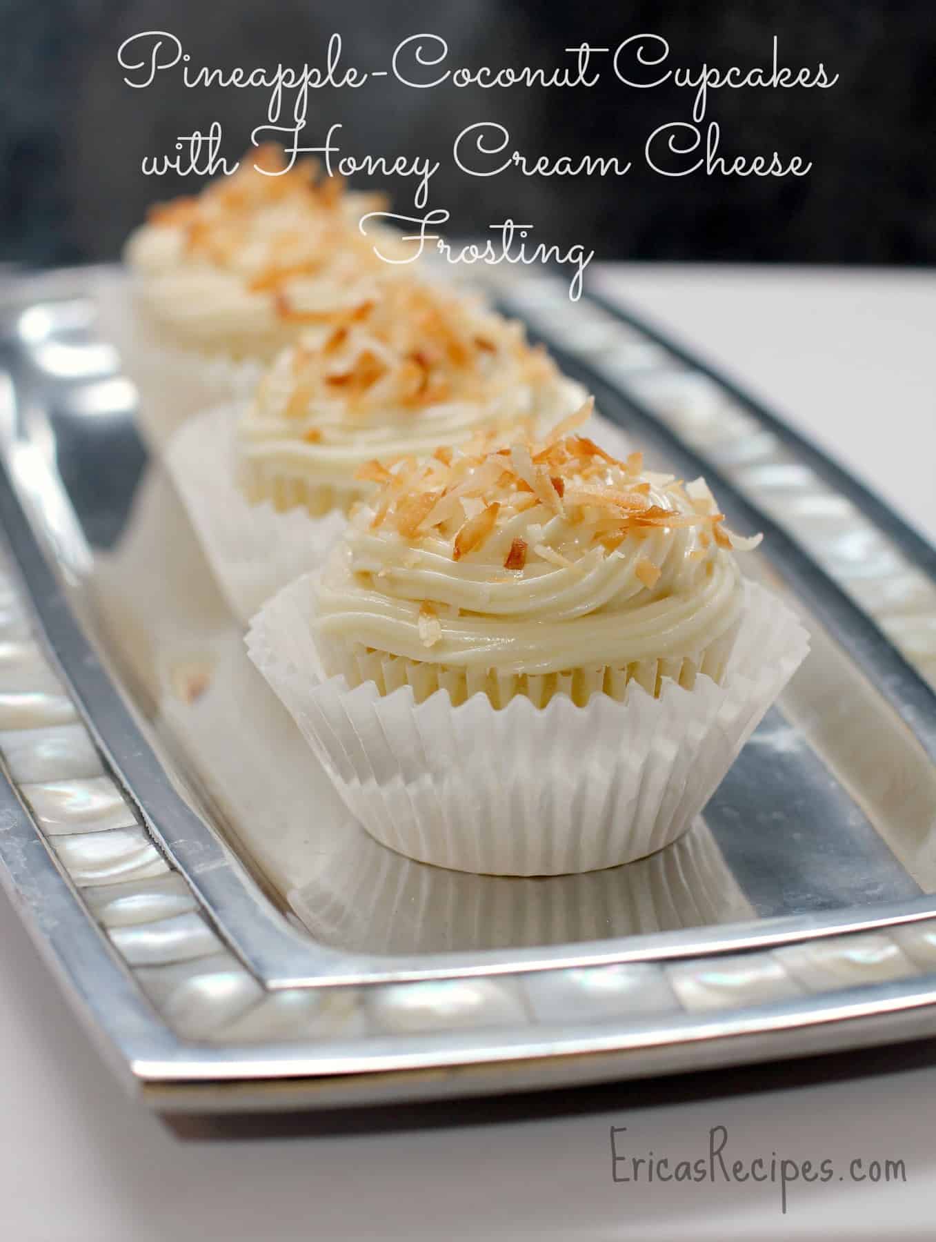Fluffy, angelic Pineapple Coconut Cupcakes with Honey Cream Cheese Frosting. These dream-like cupcakes are so luscious and decadent, with a perfect balance of sweet. #dessert #recipe #food #pineapple #coconut #cupcake #honey #creamcheese #frosting