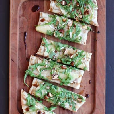 Grilled Flatbread with Brie, Arugula, Candied Nuts, and Balsamic-Honey Drizzle