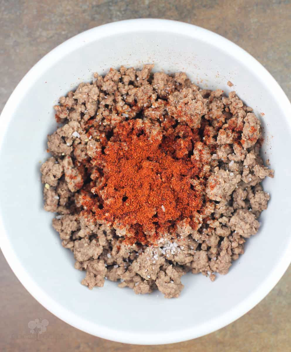 ground beef in white bowl with chili powder